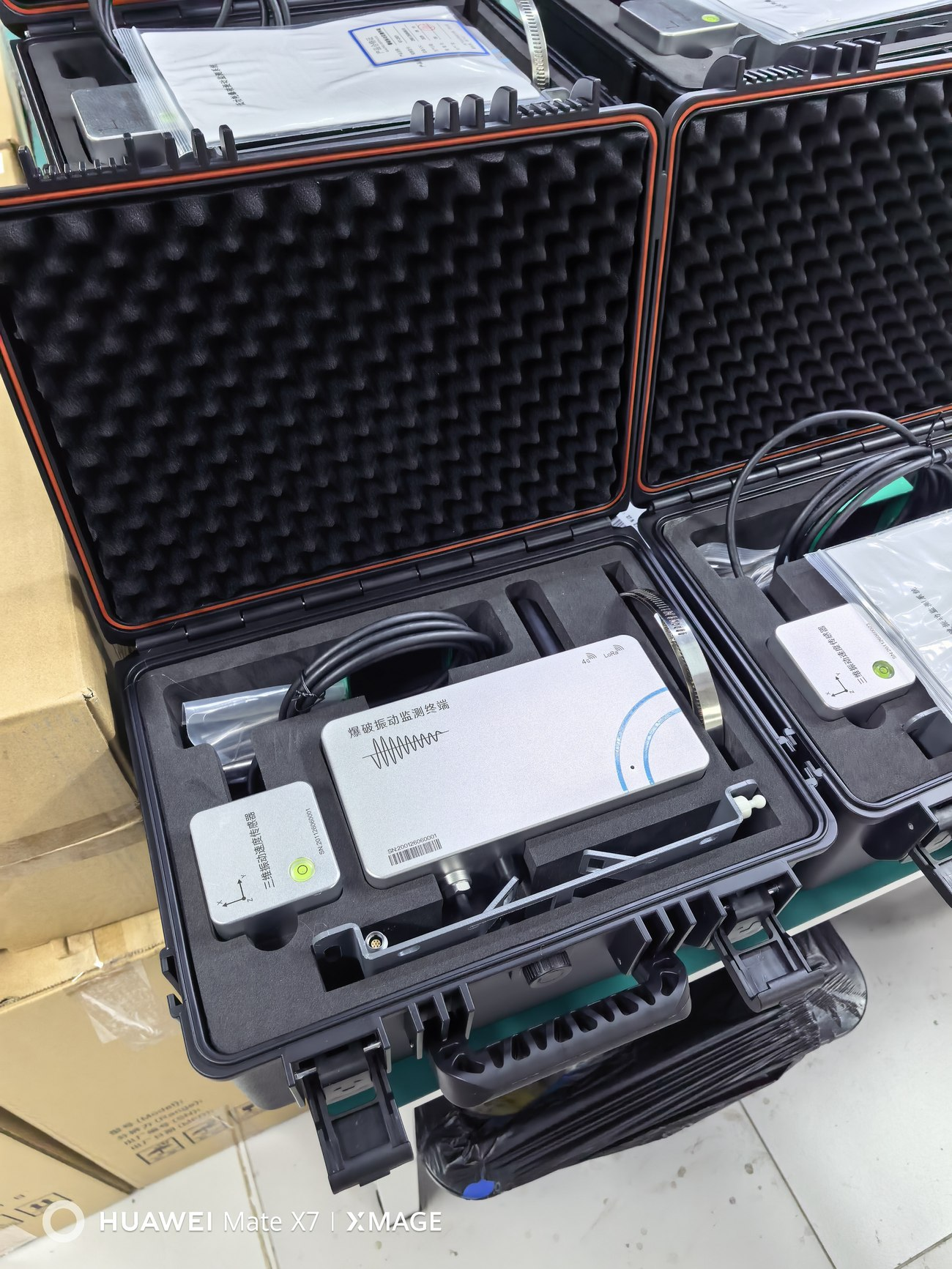 Field photograph of the terminal, sensor and accessories in their transport case.